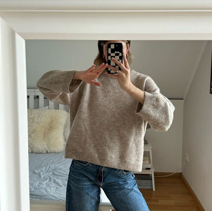 Person holding Casa Rolio Mono tufted cotton iPhone case showing slim profile and elegant design