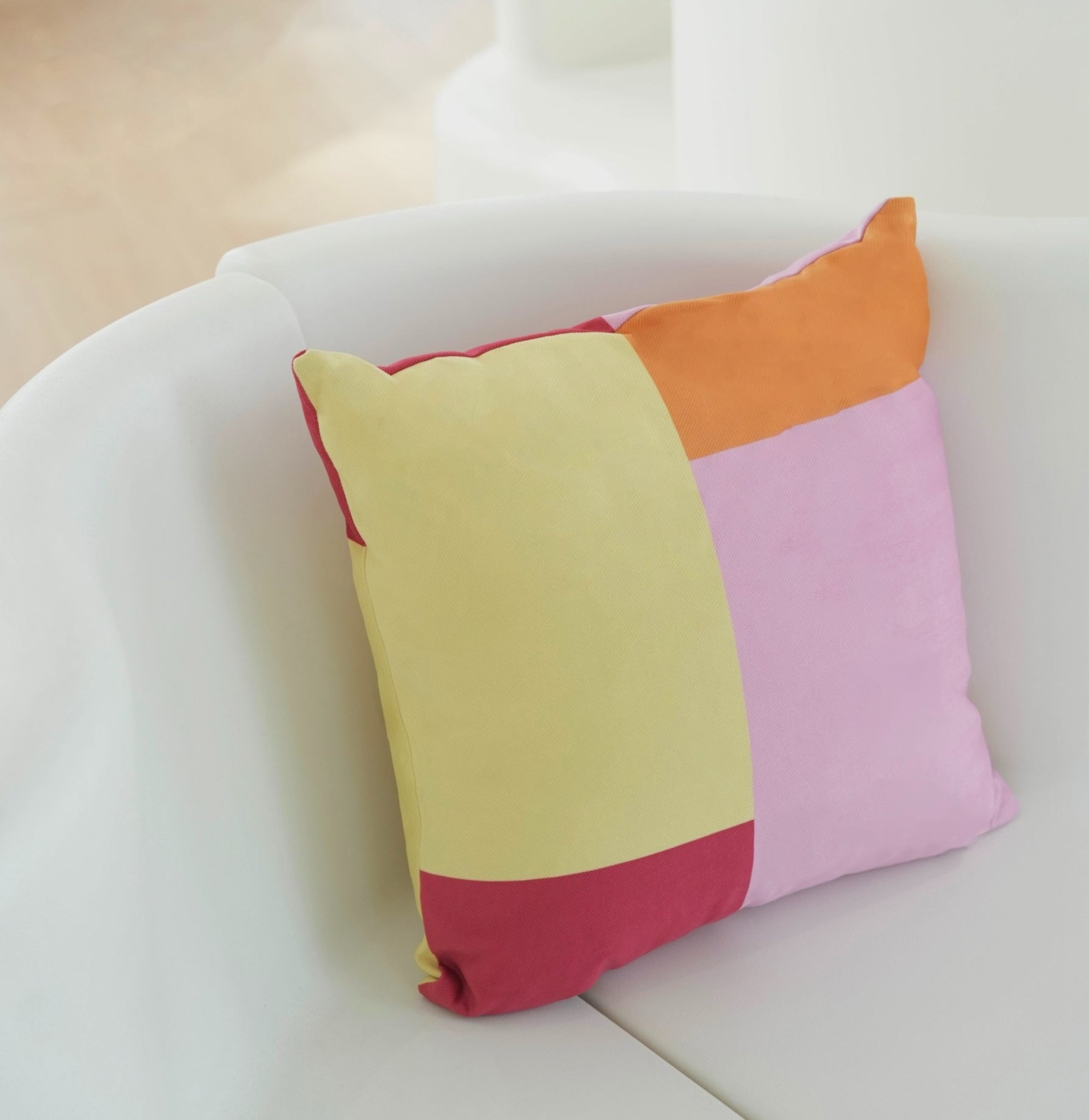 Rolio Cushion - Casa Rolio designer cushion featuring a bold geometric design with pink, red, yellow, and orange colours. A luxury cushion perfect for adding a pop of colour to any space. Ideal throw pillow for modern home decor